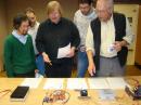 ARRL Lab Engineer Bob Allison, WB1GCM (center), presents the results of his lab evaluations to the Challenge judges as he discusses the features of each entry. Left to right: ARRL Sr Lab Engineer Zack Lau, W1VT; W1AW Station Manager Joe Carcia, NJ1Q; Bob Allison; ARRL Contest Manager Sean Kutzko, KX9X, and QST Technical Editor Joel Hallas, W1ZR. Judges not in the photo: ARRL Lab Manager Ed Hare, W1RFI, and QEX Editor Larry Wolfgang, WR1B. [S. Khrystyne Keane, K1SFA, Photo] 